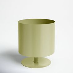 a light green lamp shade sitting on top of a table