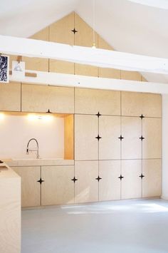 an empty kitchen with white walls and black stars on the wall