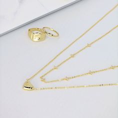 Elevate your style with the Nova Station Necklace in gold. This station necklace features sparkling CZ stones in a stunning star shape, all set in an 18K gold overlay. Add a touch of glamour to any outfit with this beautiful and versatile piece. *Also available in SILVER PRODUCT DETAILS Size: 16" + 2" extension Metal: 18k Gold Plated Brass Stone: Brilliant Cubic Zirconia Gold Minimalist Luxury Station Necklace, Minimalist Luxury Gold Station Necklace, Gold Star Necklace For Anniversary, Wedding Gold Necklace With Star Charm, Gold Wedding Jewelry With Star Charm, Gold Necklace With Star Charm For Weddings, Elegant Gold Necklace With Star Charm, Gold Wedding Necklace With Star Charm, Luxury Gold Station Necklace