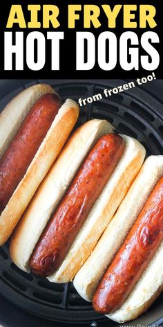 four hot dogs in buns on an air fryer with the words easy air fryer hot dogs