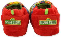 a pair of red slippers with sesame street written on the front and bottom side