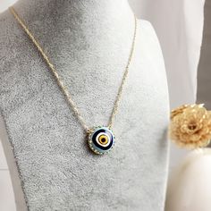 Introducing our stunning Cable Chain with a Hand-Painted 19mm Evil Eye Turkish Pendant in a Decorative Prong Setting. This gold Evil Eye Necklace is the perfect addition to any jewelry collection, with its unique design and intricate detailing. Crafted with care, this necklace features an 18+2 inch chain and a hand-painted Turkish pendant measuring 19mm in size. The evil eye symbol is said to ward off negative energy and bring good luck, making this necklace both beautiful and meaningful. Our Ca Plated Medallion Jewelry Gift, Medallion Shaped Plated Jewelry Gift, Gold Evil Eye Amulet Jewelry, Handmade Yellow Gold Enamel Necklaces, Handmade Yellow Gold Enamel Necklace, Yellow Gold Enamel Jewelry With Adjustable Chain, Handmade Gold Enamel Necklaces, Gold Chain Necklace Gift, Round Enamel Necklace With Adjustable Chain