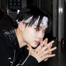 a young man with black hair and piercings