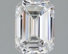 an emerald cut diamond is displayed on a gray background, with the center stone visible