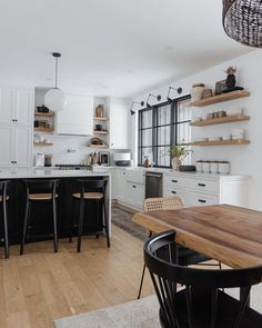 the kitchen is clean and ready to be used for cooking or dining, with white cabinets and black appliances