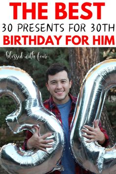 a man holding two large silver balloons in front of him with the words 30 birthday for him