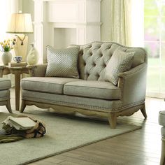 a living room scene with focus on the couch and chair, coffee table and vase