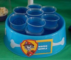 there is a blue bowl with cups in it