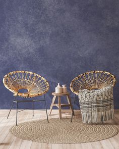 two wicker chairs sitting on top of a wooden floor