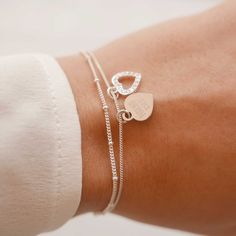 "Engraved Women's Personalized Heart Charm Sterling Silver Dainty Delicate Bracelet, Mom Gift --------------------------------------------------------------------------------------------------------------------- Delicate, classical, and feminine heart charm design. This gorgeous silver bracelet has got two 925 Sterling Silver heart pendants, on one of which you can engrave your personal message. GET CREATIVE and make it a ONE-OF-A-KIND with an engraving of your choice: initials, birthday, coordi Personalized Heart Bracelet, Eye Ring Silver, Custom Engraved Bracelet, Personalized Leather Bracelet, Silver Heart Bracelet, Bff Gift, Hammered Hoop Earrings, Bracelet Love, Sterling Silver Heart Pendant