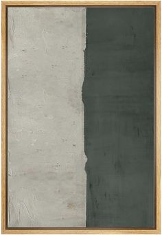 an abstract painting with grey and white paint on the wall, framed in wooden frame