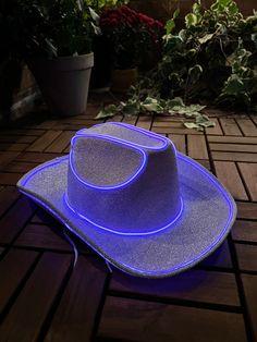 "**Be sure to check out my new website linked on my page or by going to www.howdy.company! Welcome to my shop! All of my cowboy hats have a unique and eye catching design that will make you stand out at any event. I hand make each Iight up cowboy hat to match your color preference. My new sparkly cowboy hat shimmers in the light to give your outfit an even more unique look. The hat also does not shed like typical glitter products so you don't have to worry about it making a mess. For the Iights, Country Style Fedora Party Hat, Country Style Fedora Hat For Party, Country Style Short Brim Hat For Party, Country Style Wide Brim Party Hat, Adjustable Fun Hat For Western-themed Events, Light Up Hats, Rave Hats, Bachelorette Hats, Embroidery Crewneck