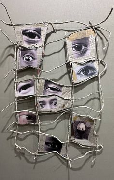 an art piece made out of newspaper with eyes on it's sides and branches