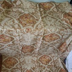 an unmade bed with a brown and white comforter