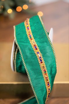 a close up of a green ribbon on a table