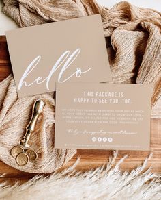 two thank cards with gold handles on top of a pile of brown and white yarn