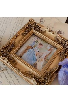 an old photo frame sitting on top of a piece of paper next to some scissors