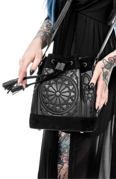 Embrace your inner goth with our goth black sanctum bucket bag. crafted with meticulous attention to detail, this bag seamlessly combines dark aesthetics with practicality. perfect for carrying your essentials, it exudes an aura of mystery and elegance that will make heads turn wherever you go Luxury Bucket Bag With Metal Details, Cheap Punk Halloween Bags, Punk Style Halloween Bags, Luxury Travel Bucket Bag With Leather Lining, Cheap Black Alternative Style Bags, Affordable Gothic Halloween Bags, Cheap Alternative Black Bags, Cheap Gothic Bags For Halloween, Window Embroidery