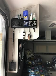 the inside of a camper with a bed and shelf on it's side