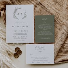 the wedding stationery is laid out on a blanket