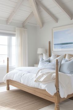 a bed with white sheets and pillows in a bedroom