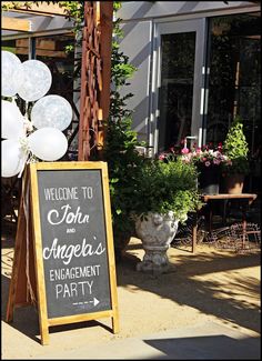 a welcome sign with balloons in front of a building that says,'welcome to john and angelia's engagement party '