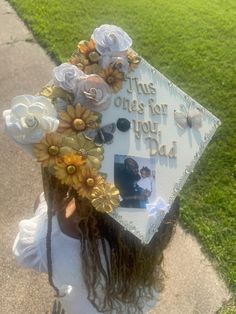 a graduation cap decorated with flowers and photos