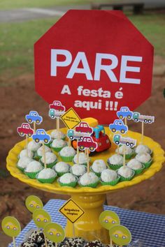 a table topped with cakes and cupcakes on top of a yellow cake plate