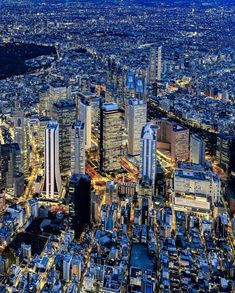 an aerial view of the city lights and skyscrapers at night in tokyo, japan