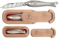 three different types of fish in wooden cases with knives and spoons on top of each other