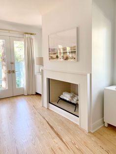 a living room with hardwood floors and white walls