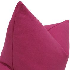 a close up view of a pink pillow on a white background with the fabric folded down