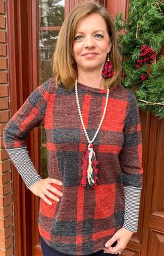 This top screams Christmas. This would make a great top for family pictures. Featuring the red buffalo plaid with black and white striped sleeves. Pair with our buffalo plaid tassel necklace, our buffalo plaid earrings, and jeans or leggings and you have a great Christmas outfit. Fits true to size. Sizes S-XL 87% Polyester, 8% Rayon, 5% Spandex Plaid Earrings, Stripes Top, Red Buffalo Plaid, Striped Sleeve, Family Pictures, Buffalo Plaid, Christmas Outfit, Tassel Necklace, Buffalo