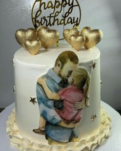 a cake decorated with two people hugging each other