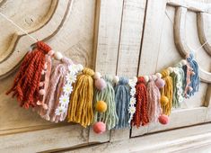 the colorful tassels are hanging on the wall