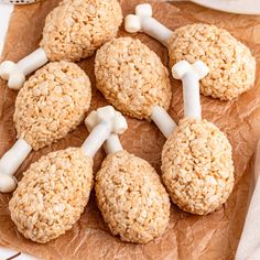 cookies with marshmallows and bones are arranged on top of brown parchment paper