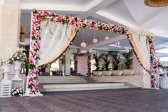 a decorated stage with flowers and greenery for a wedding or reception at the resort