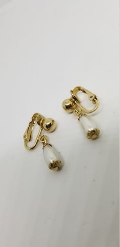 Vintage Sarah Coventry dainty dangle pearl earrings Pretty and dainty little earrings Gold tone metal with a single pearl drop Clip on non pierced closure Signed Sara Cov 1 1/8 inch total length In excellent vintage condition. May have an occasional light scratch? Dangle Pearl Earrings, Earrings Pretty, Single Pearl, Sarah Coventry, Pearl Earrings Dangle, Coventry, Gold Flowers, Pearl Drop, Black Enamel