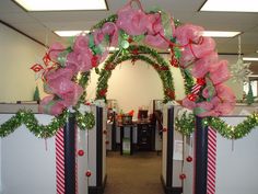 an office cubicle decorated for christmas with candy canes and bows on the front door