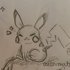 a drawing of a pikachu sitting on top of a table next to a laptop computer