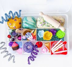 a plastic container filled with lots of different types of candies and cupcakes