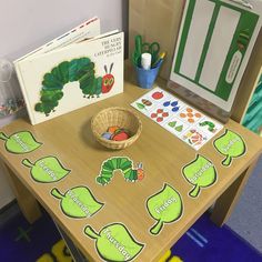 the very hungry caterpillar board game is set up on a small wooden table