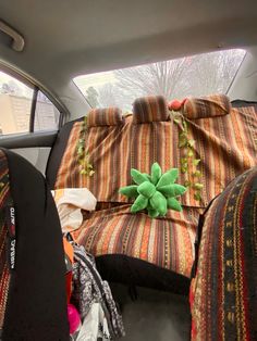 the back seat of a car with decorative cushions