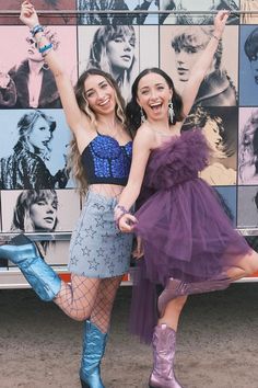 two women standing next to each other in front of a truck