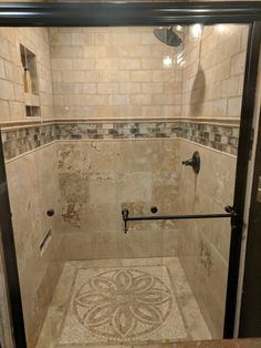 a walk in shower sitting inside of a bathroom next to a tiled floor and walls