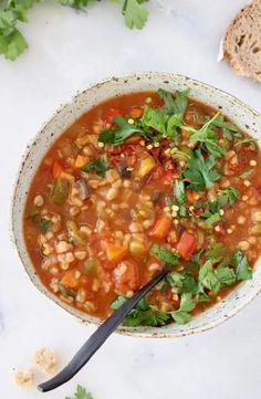 a white bowl filled with soup and garnished with cilantro