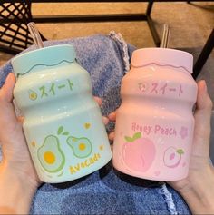 two children's sippy cups with the words hey peach and avocado printed on them