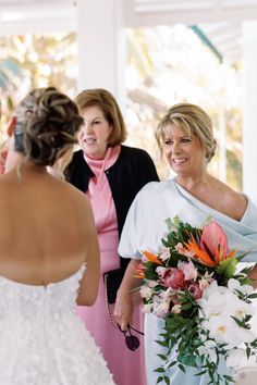 two women standing next to each other at a wedding