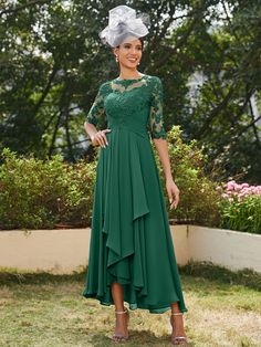 a woman wearing a green dress and hat