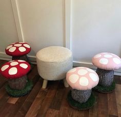 three mushrooms sitting on top of grass covered ground next to a white chair and footstool